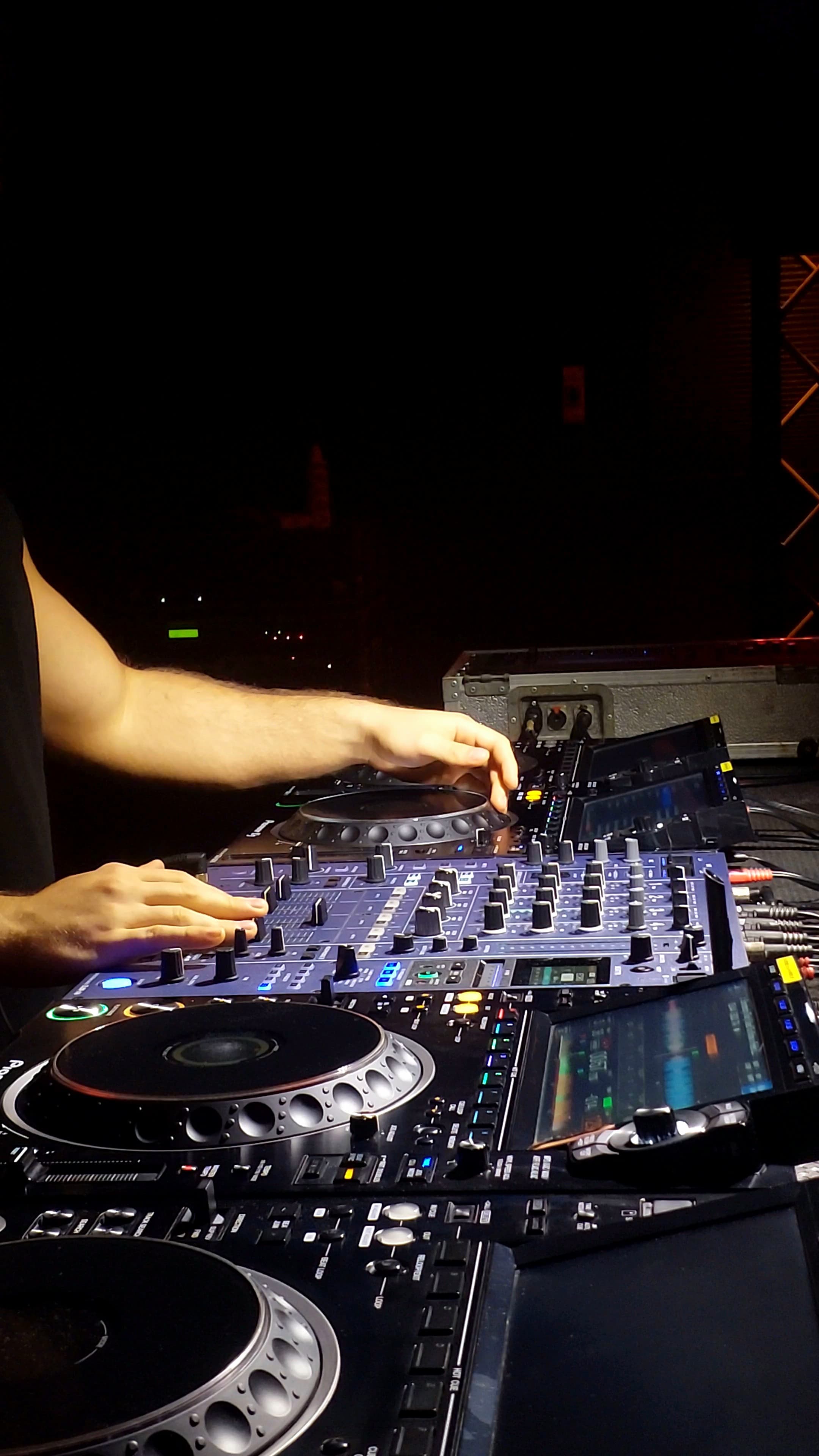 Close view of FRIXX using both hands to beatmatch on professional DJ decks.