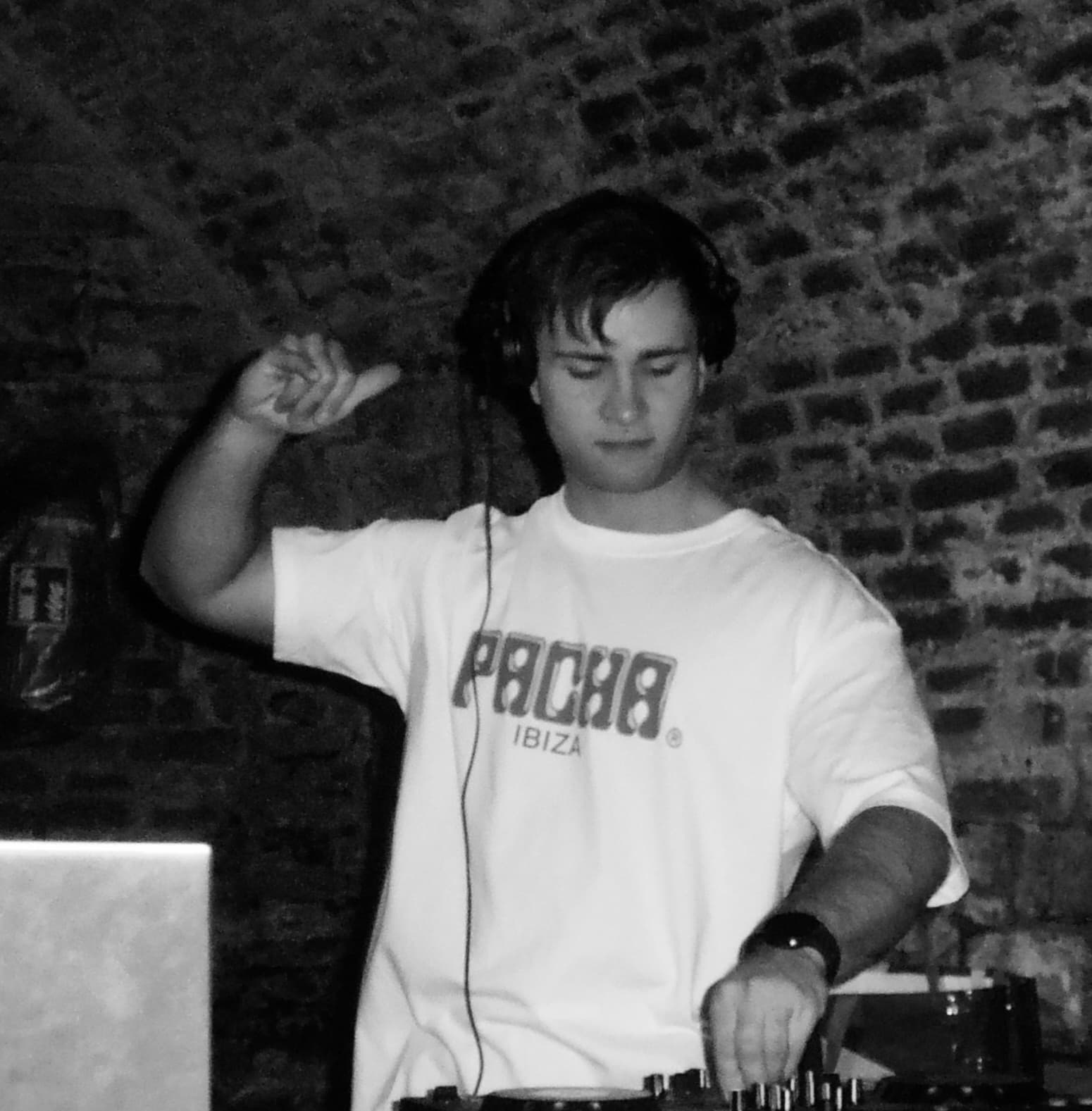 Black-and-white portrait of FRIXX mixing at the decks.